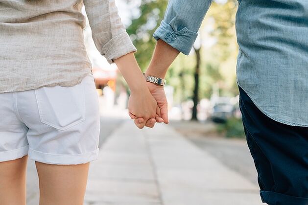 A man without potency problems holds a woman's hand